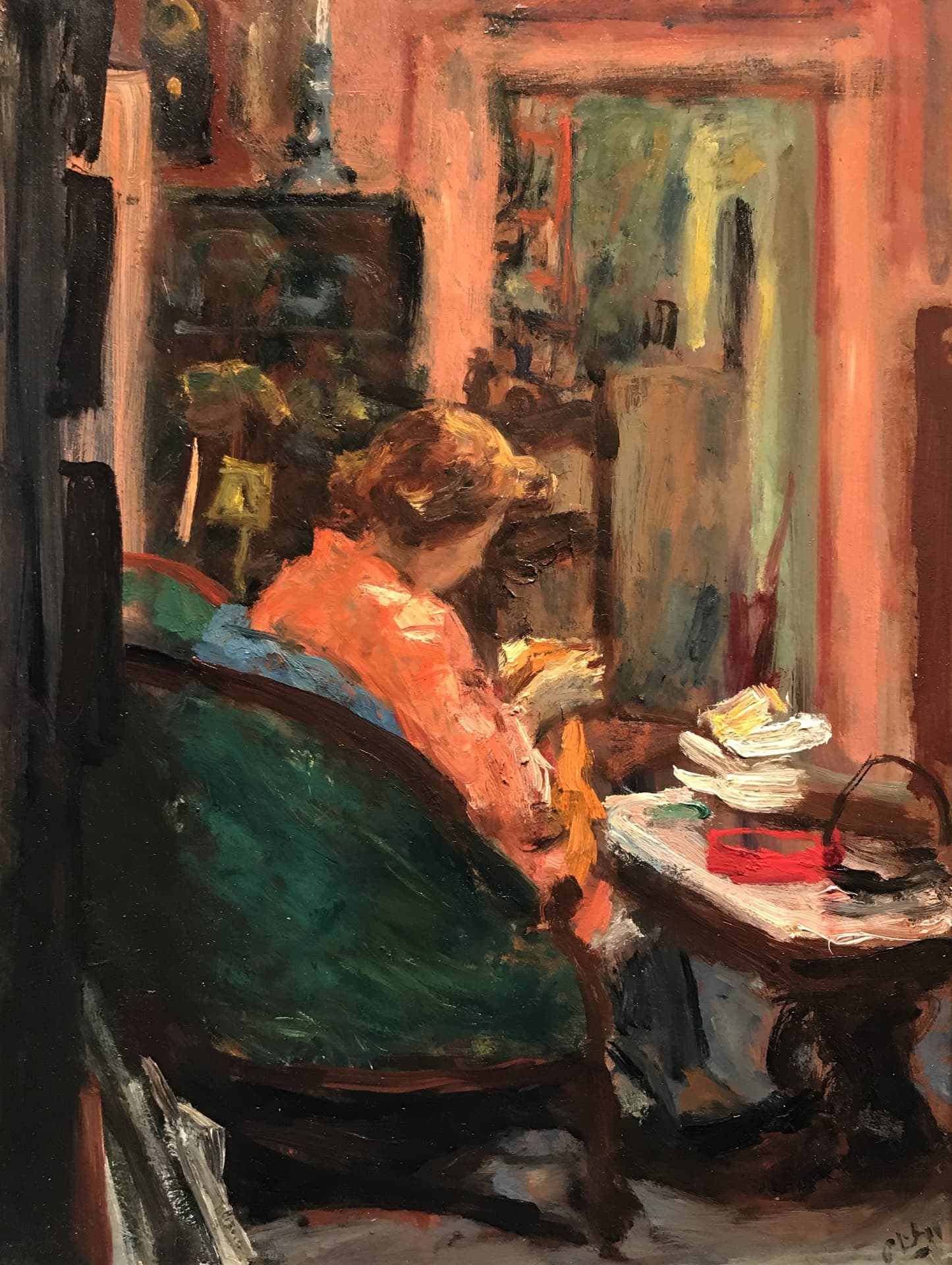 Robert Philipp's Quiet Time. A mature woman sits on a tall backed green couch, facing away from the viewer, stitching or knitting yellow fabric. The room is full but cozy. Darker colors.